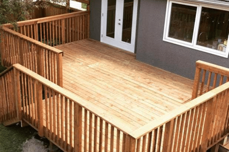 Wooden deck of a grey house- Calgary deck builders